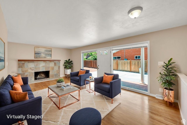 2864 N 175 E, Provo, UT 84604 - living area featuring wood finished floors, a tiled fireplace, and baseboards