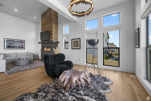 12277 S Emory Peak Cv Unit 404, Herriman, UT 84096 - living area with a high ceiling, a large fireplace, wood finished floors, baseboards, and recessed lighting