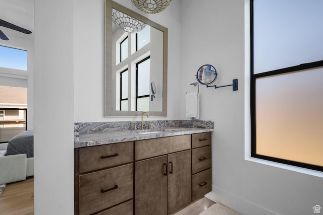 12277 S Emory Peak Cv Unit 404, Herriman, UT 84096 - bathroom with plenty of natural light, vanity, connected bathroom, and ceiling fan
