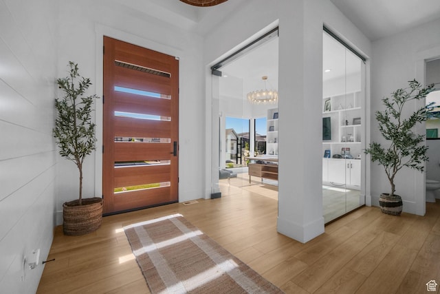 12277 S Emory Peak Cv Unit 404, Herriman, UT 84096 - entrance foyer with light wood-type flooring and a chandelier