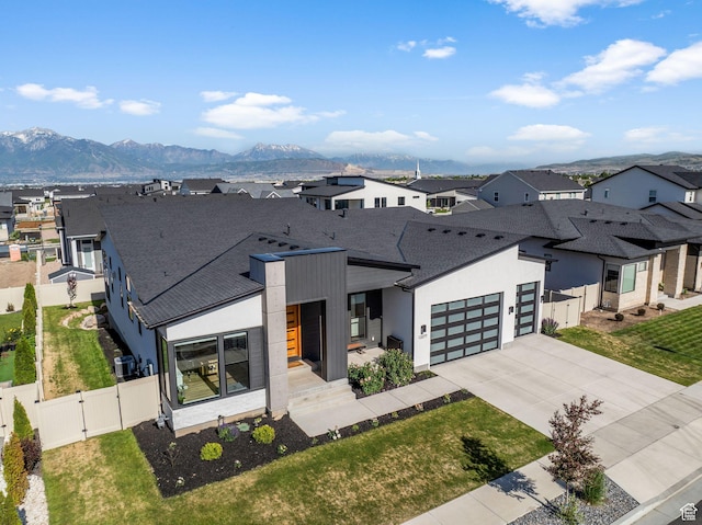 12277 S Emory Peak Cv Unit 404, Herriman, UT 84096 - modern home featuring a gate, a residential view, an attached garage, and concrete driveway