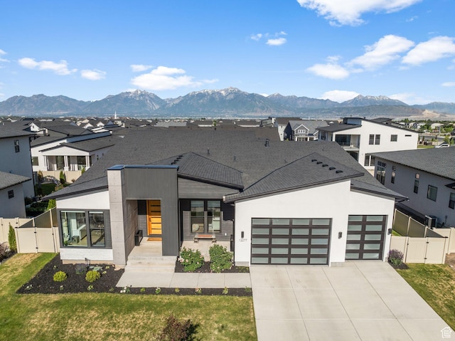 12277 S Emory Peak Cv Unit 404, Herriman, UT 84096 - contemporary home with a gate, an attached garage, a residential view, and concrete driveway