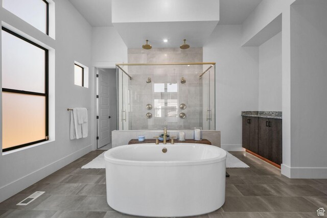12277 S Emory Peak Cv Unit 404, Herriman, UT 84096 - full bathroom with a stall shower, a freestanding bath, and baseboards