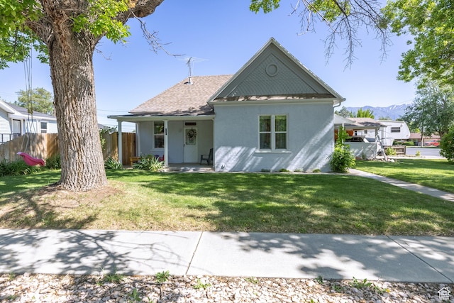 389 E 200 N, Spanish Fork, UT 84660 - view of front of house featuring stucco siding, a mountain view, a shingled roof, and covered porch