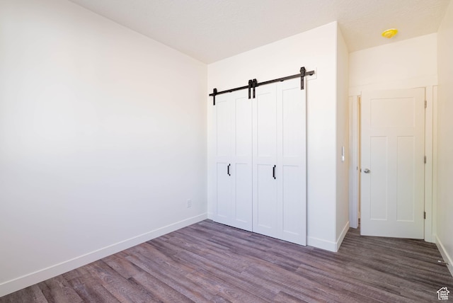 155 N 800 W, Vernal, UT 84078 - unfurnished bedroom featuring dark wood-style floors and a barn door