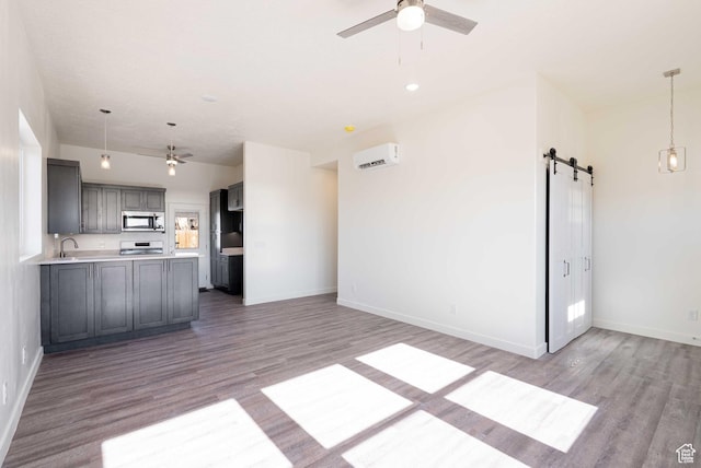 155 N 800 W, Vernal, UT 84078 - kitchen with stainless steel microwave, a barn door, a ceiling fan, and open floor plan