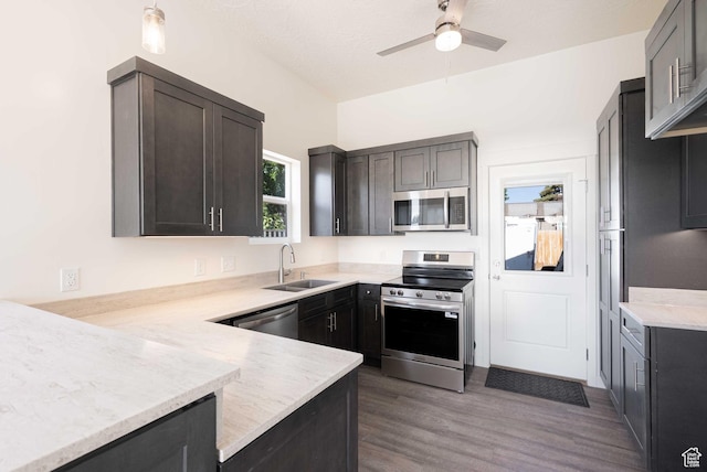 155 N 800 W, Vernal, UT 84078 - kitchen featuring stainless steel appliances, ceiling fan, dark wood-style flooring, a peninsula, and light stone counters