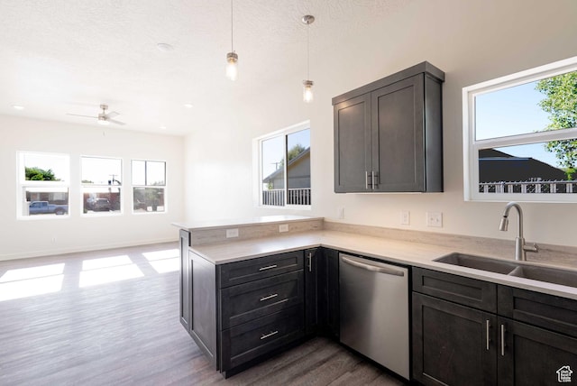 155 N 800 W, Vernal, UT 84078 - kitchen with stainless steel dishwasher, healthy amount of natural light, dark wood-type flooring, a peninsula, and a textured ceiling