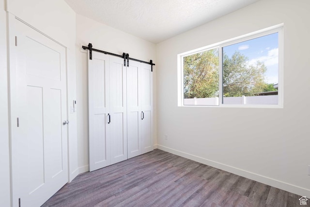 155 N 800 W, Vernal, UT 84078 - unfurnished bedroom with wood finished floors, a barn door, and a closet