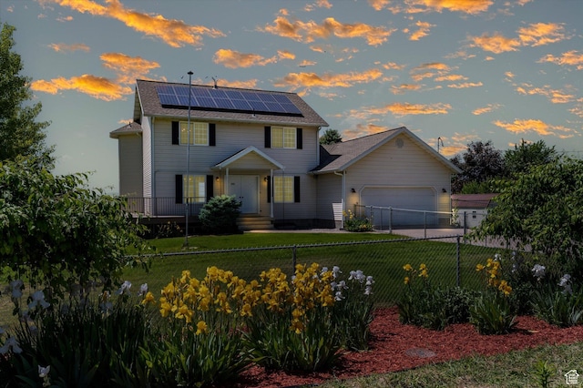 2951 N 1200 E, North Logan, UT 84341 - colonial house featuring roof mounted solar panels, a garage, and a shingled roof
