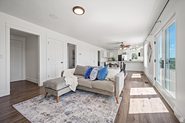 2951 N 1200 E, North Logan, UT 84341 - living room with dark wood-style floors, a ceiling fan, and baseboards