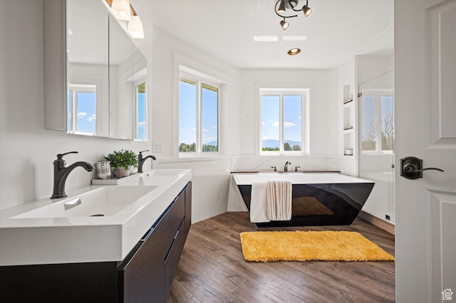 2951 N 1200 E, North Logan, UT 84341 - full bathroom featuring a freestanding bath, double vanity, wood finished floors, and recessed lighting