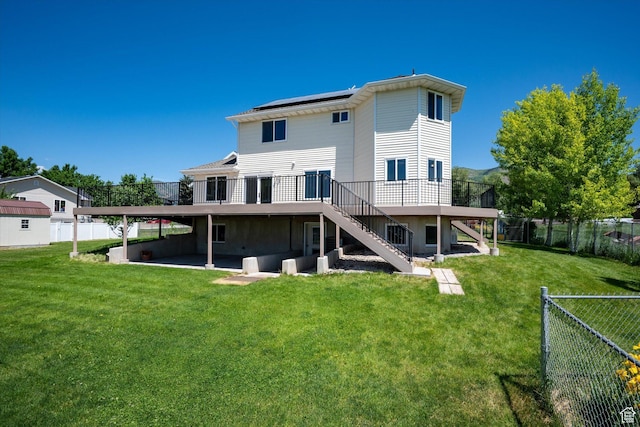 2951 N 1200 E, North Logan, UT 84341 - rear view of property with stairway, a wooden deck, a patio area, and roof mounted solar panels