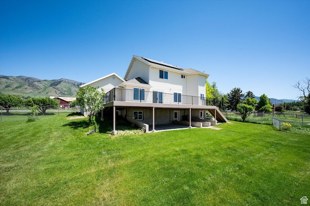 2951 N 1200 E, North Logan, UT 84341 - rear view of house featuring a deck with mountain view, a patio, roof mounted solar panels, and stairs