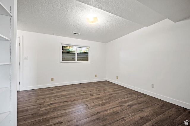 2951 N 1200 E, North Logan, UT 84341 - spare room featuring dark wood-type flooring, baseboards, and a textured ceiling