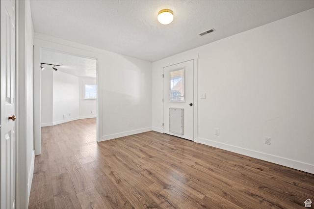 2951 N 1200 E, North Logan, UT 84341 - unfurnished room featuring wood finished floors, baseboards, and a textured ceiling