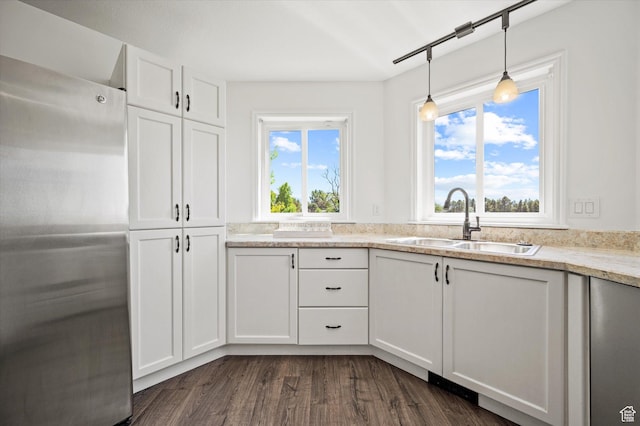 2951 N 1200 E, North Logan, UT 84341 - kitchen featuring freestanding refrigerator, a sink, white cabinets, dark wood-style flooring, and decorative light fixtures