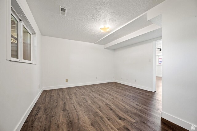 2951 N 1200 E, North Logan, UT 84341 - spare room featuring a textured ceiling, dark wood finished floors, and baseboards