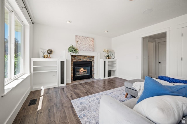 2951 N 1200 E, North Logan, UT 84341 - living area with baseboards, dark wood-type flooring, a stone fireplace, and recessed lighting