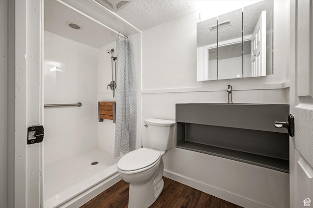2951 N 1200 E, North Logan, UT 84341 - full bathroom with toilet, wood finished floors, a shower with curtain, a textured ceiling, and vanity