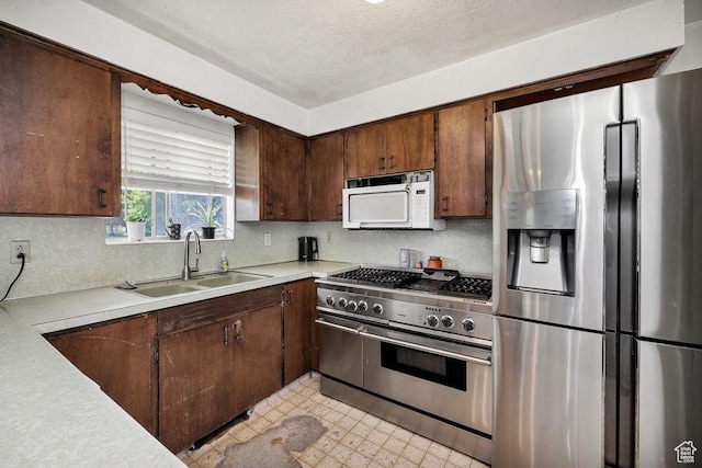 8765 S 300 W, Paradise, UT 84328 - kitchen featuring stainless steel appliances, a sink, light countertops, backsplash, and light floors
