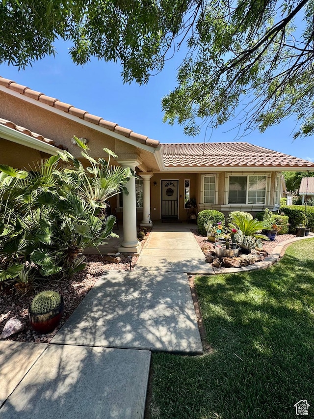 1825 W Mathis Park Pl Unit 13, St George, UT 84770 - view of front facade with a tiled roof and a front lawn
