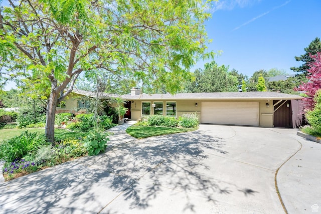 2967 E Branch Dr S, Holladay, UT 84117 - ranch-style home featuring driveway, an attached garage, a chimney, and stucco siding