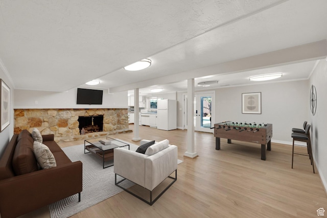 2967 E Branch Dr S, Holladay, UT 84117 - living area with light wood finished floors, baseboards, a stone fireplace, ornamental molding, and decorative columns
