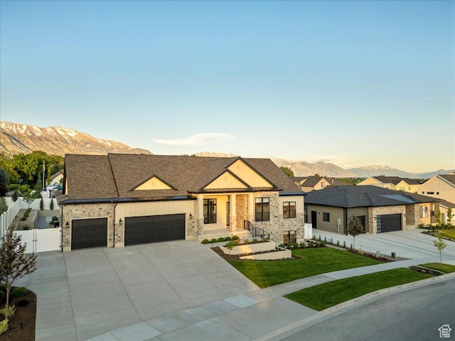 812 N 780 W, American Fork, UT 84003 - view of front of property featuring a mountain view, a garage, concrete driveway, a gate, and stone siding