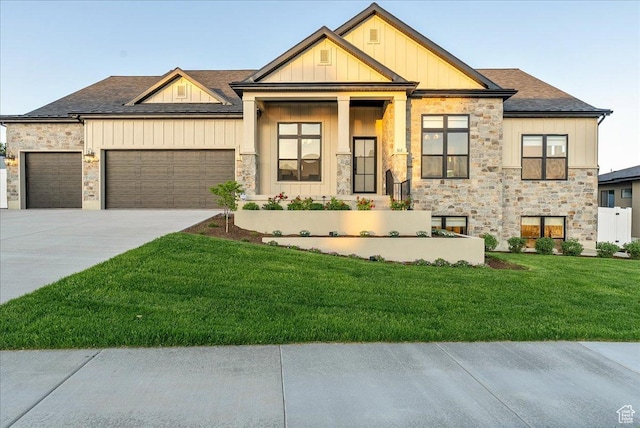 812 N 780 W, American Fork, UT 84003 - view of front of property featuring stone siding, a front yard, an attached garage, board and batten siding, and concrete driveway