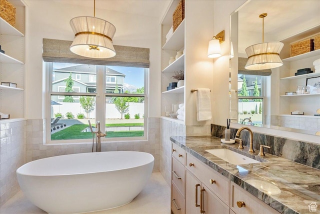 812 N 780 W, American Fork, UT 84003 - full bathroom featuring tile walls, vanity, a soaking tub, and plenty of natural light