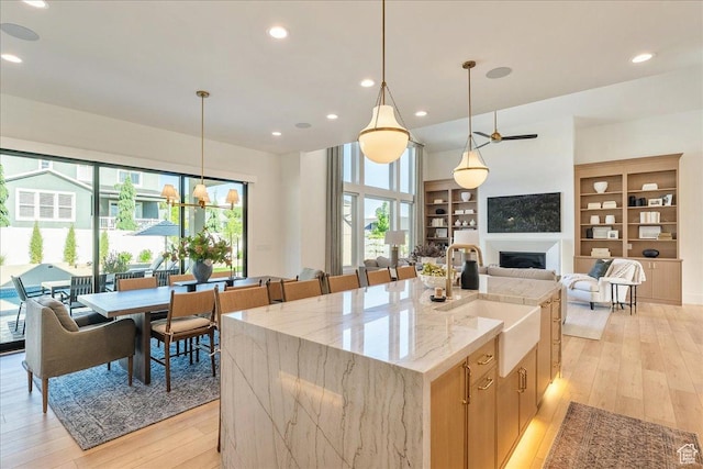 812 N 780 W, American Fork, UT 84003 - kitchen with a sink, light wood-style floors, healthy amount of natural light, a kitchen island with sink, and recessed lighting