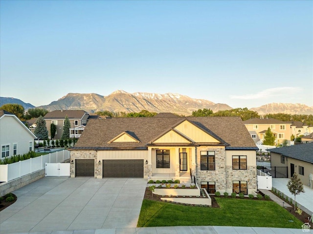 812 N 780 W, American Fork, UT 84003 - view of front facade with stone siding, a mountain view, a gate, and a garage