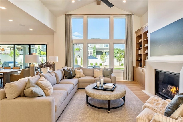 812 N 780 W, American Fork, UT 84003 - living area featuring high vaulted ceiling, light wood finished floors, a glass covered fireplace, and recessed lighting