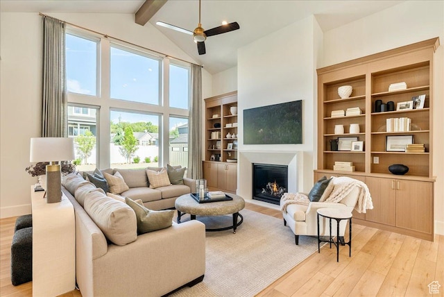 812 N 780 W, American Fork, UT 84003 - living area with light wood finished floors, beamed ceiling, a warm lit fireplace, high vaulted ceiling, and ceiling fan