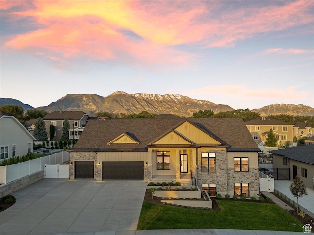 812 N 780 W, American Fork, UT 84003 - view of front facade featuring stone siding, a gate, a mountain view, concrete driveway, and a garage
