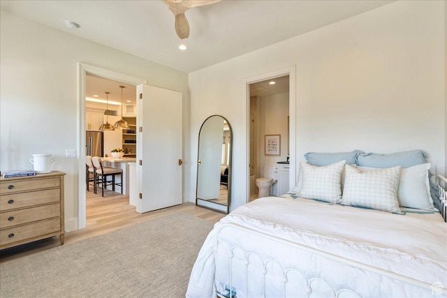 807 N 780 W, American Fork, UT 84003 - bedroom with light wood finished floors, recessed lighting, ensuite bath, and arched walkways