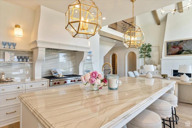 807 N 780 W, American Fork, UT 84003 - kitchen with a chandelier, a high ceiling, white cabinets, light stone countertops, and backsplash