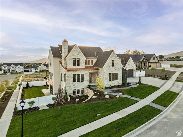 807 N 780 W, American Fork, UT 84003 - view of front of home with stone siding, a standing seam roof, concrete driveway, a chimney, and a garage