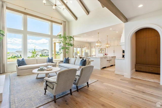 807 N 780 W, American Fork, UT 84003 - living room with a chandelier, beam ceiling, high vaulted ceiling, light wood-style floors, and recessed lighting