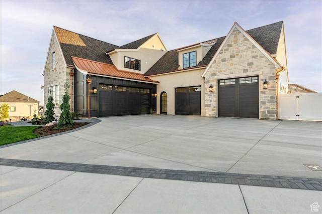 807 N 780 W, American Fork, UT 84003 - view of front facade featuring stone siding, an attached garage, a standing seam roof, stucco siding, and driveway