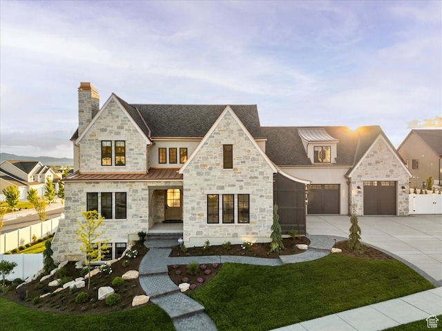 807 N 780 W, American Fork, UT 84003 - view of front of property featuring a standing seam roof, stone siding, concrete driveway, a chimney, and metal roof