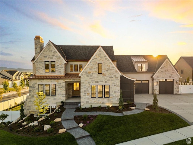 807 N 780 W, American Fork, UT 84003 - view of front of home with a standing seam roof, stone siding, concrete driveway, a chimney, and metal roof