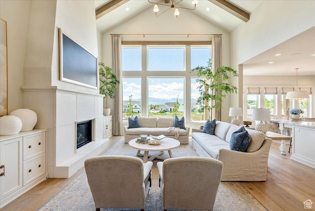 807 N 780 W, American Fork, UT 84003 - living area with high vaulted ceiling, light wood-type flooring, beam ceiling, a glass covered fireplace, and recessed lighting