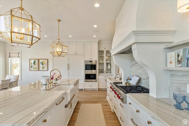 807 N 780 W, American Fork, UT 84003 - kitchen featuring a chandelier, stainless steel appliances, white cabinetry, glass insert cabinets, and light stone counters