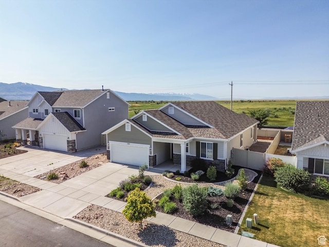 1165 W Silver Hollow Rd, Syracuse, UT 84075 - view of front of house featuring stone siding, a mountain view, concrete driveway, board and batten siding, and a garage