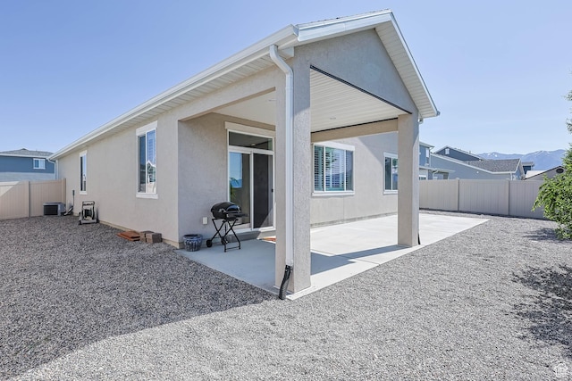 1165 W Silver Hollow Rd, Syracuse, UT 84075 - rear view of property featuring stucco siding, cooling unit, and a patio area