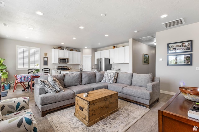 1165 W Silver Hollow Rd, Syracuse, UT 84075 - living area featuring recessed lighting, baseboards, and a textured ceiling