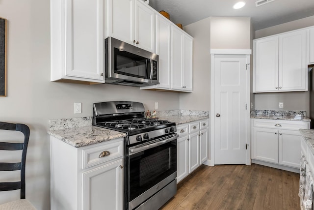 1165 W Silver Hollow Rd, Syracuse, UT 84075 - kitchen featuring appliances with stainless steel finishes, dark wood-style floors, white cabinets, light stone countertops, and recessed lighting