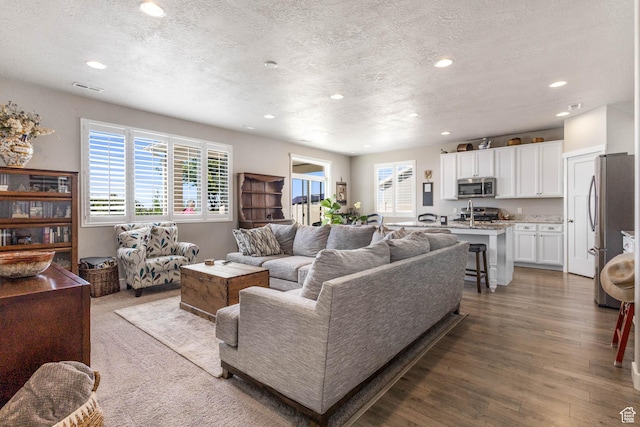 1165 W Silver Hollow Rd, Syracuse, UT 84075 - living area with recessed lighting, a textured ceiling, and wood finished floors